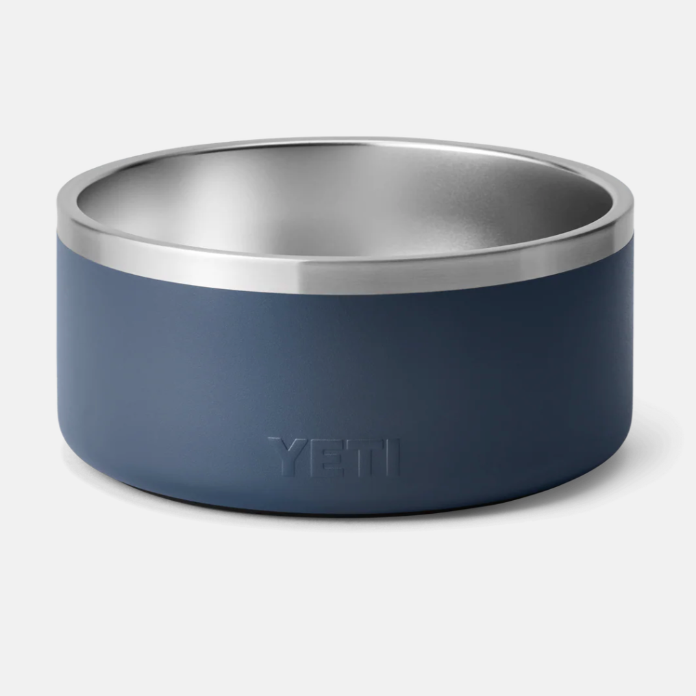 Blue YETI dog bowl with a silver interior on a light gray background